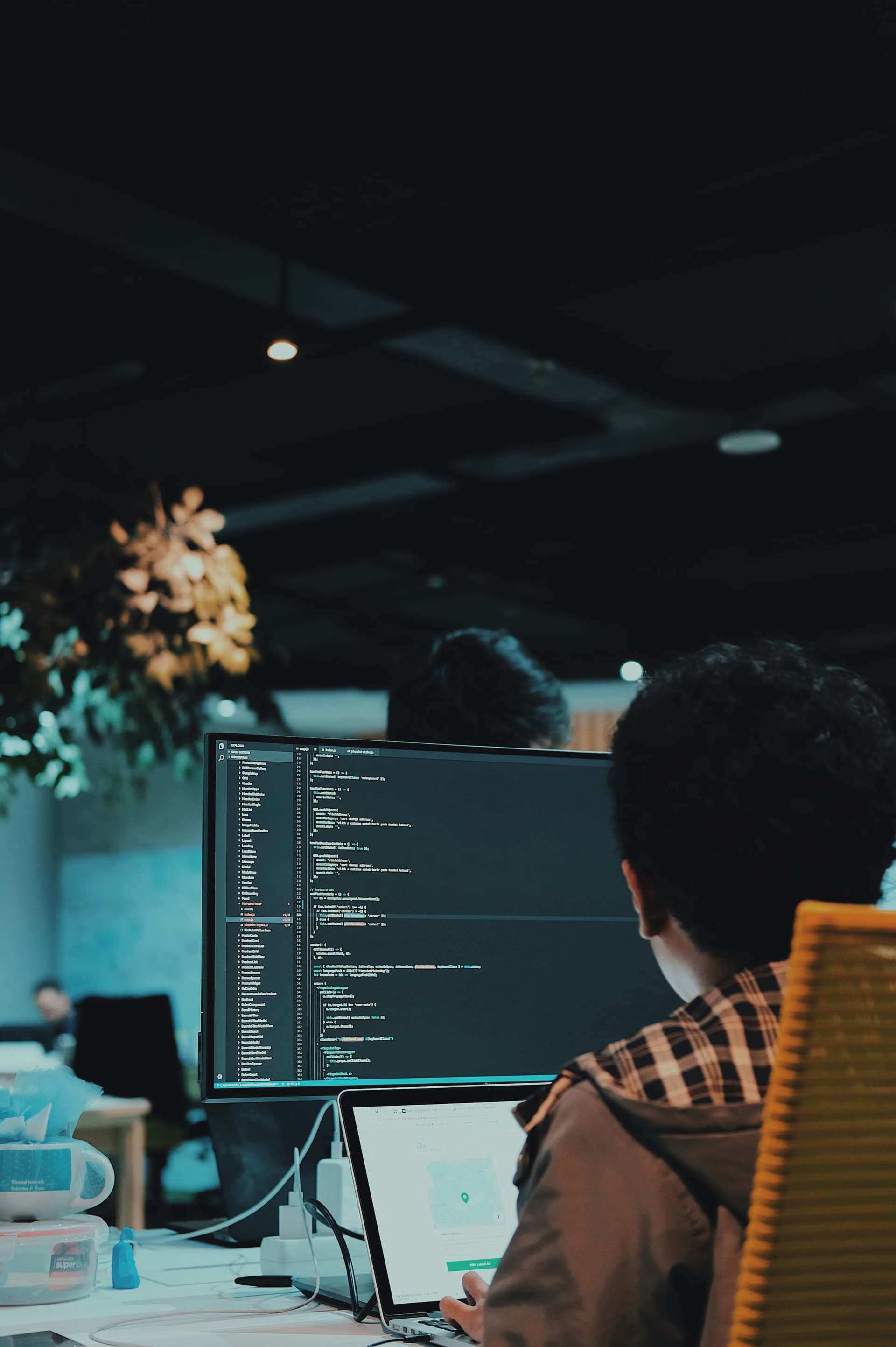 Developer writing code on a large monitor while building a scalable startup MVP